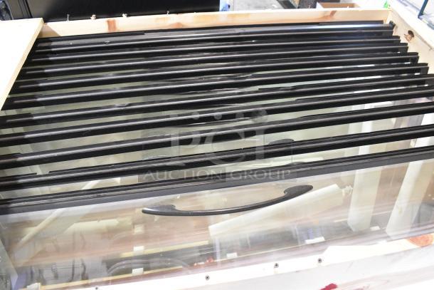 Brand new in crate, 10 Anthony doors, 23-1/8"x60", pristine condition, black frames, glass panels, ideal for display cases.