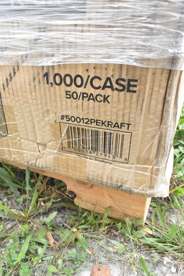 Cardboard box labeled "1,000/CASE, 50/PACK" with barcode visible, showing scratch and dent damage. Contains napkins, cups, containers.