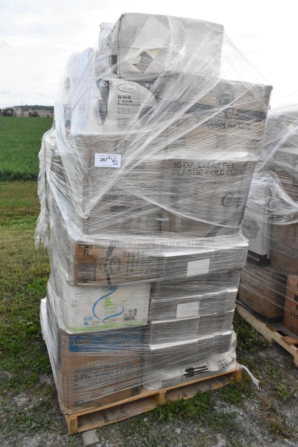 Pallet of assorted scratch and dent items including paper bags, towels, and plastic cups, wrapped in plastic.