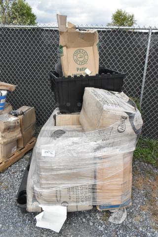 Pallet with assorted scratch and dent items, including Choice Clear PET customizable plastic cold cups and black poly bin, wrapped in plastic.