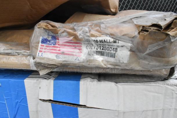Stack of packaged items with visible American flag sticker and barcode. Includes choice black 3-tier stand, aluminized steel pancake pan.