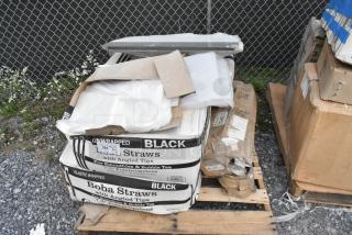 Boxes of 485UB7BK black smoothie straws and Scott toilet paper dispenser, new condition, on a pallet.