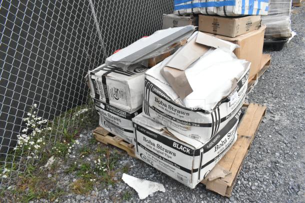 Boxes of Choice 485UB7BK unwrapped black smoothie straws and other items on a pallet, some damage visible.