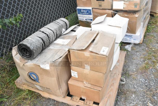 Nine brand new scratch and dent items on a pallet, including a black floor mat and boxes labeled "7014 Hot Dog Kraft."