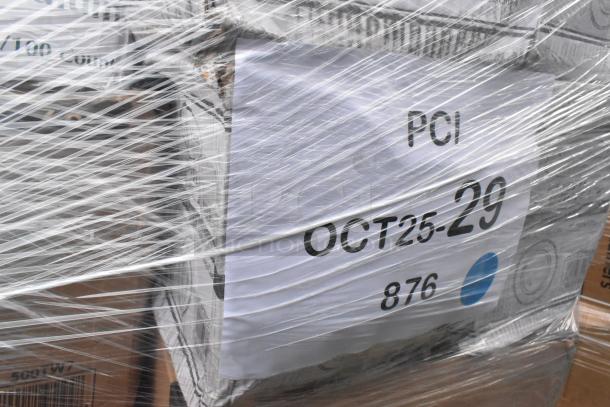 Plastic-wrapped pallet with assorted brand new scratch and dent items, including containers and plasticware. Label reads "PCI OCT25-29, 876".