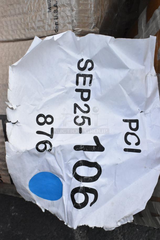 Crushed paper label with "SEP25-106 PCI 876" on a cardboard surface, indicating lot identification for auction items.