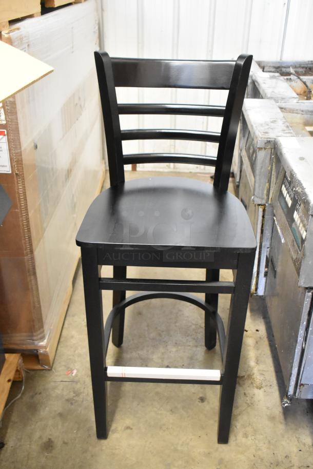 Black bar height ladder back chair by Lancaster Table & Seating, brand new, scratch and dent condition, wooden seat.