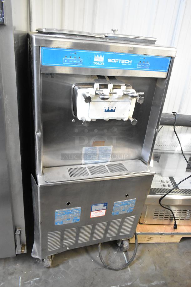 Taylor 754-27 stainless steel 2-flavor soft serve ice cream machine, commercial casters, used, 208-230V, 1 phase, model visible.
