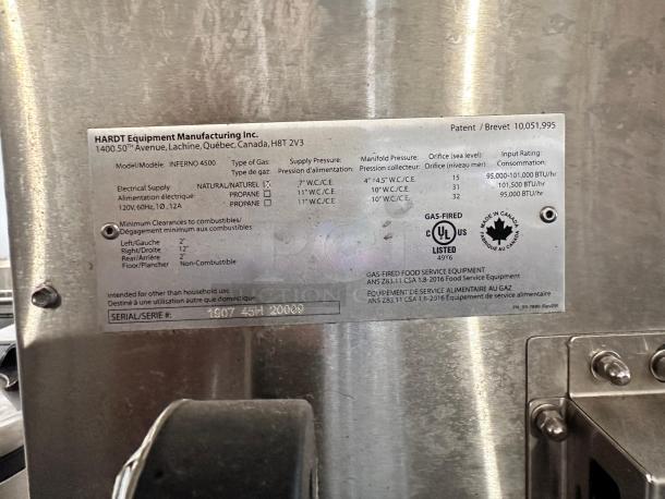 Metal tag on Hardt Inferno 4500 rotisserie oven. Displays electrical, gas info, safety certifications; made in Canada.