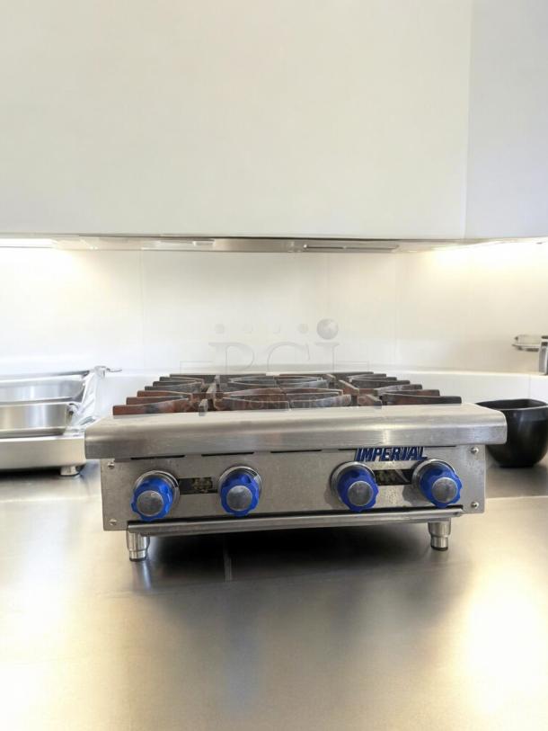 Imperial 4-Burner Gas Hot Plate, excellent condition, tested, blue knobs, stainless steel, natural gas, front view.