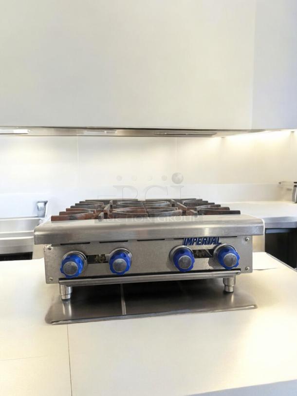 Imperial 4-Burner Gas Hot Plate, excellent condition, natural gas, fully tested, blue knob controls, stainless steel finish.
