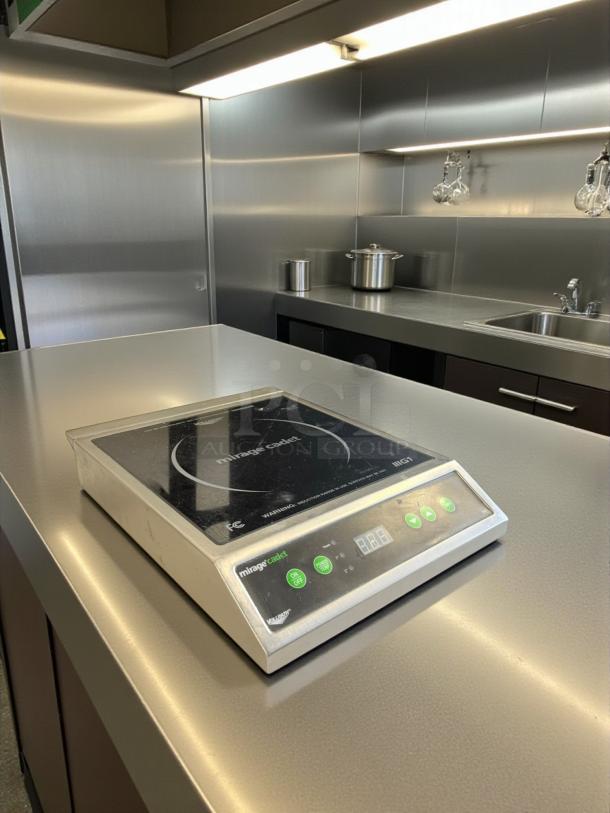 Vollrath Mirage Cadet Induction Range, model 59300, 120V, 1800W, excellent condition, fully tested, placed on stainless steel counter.