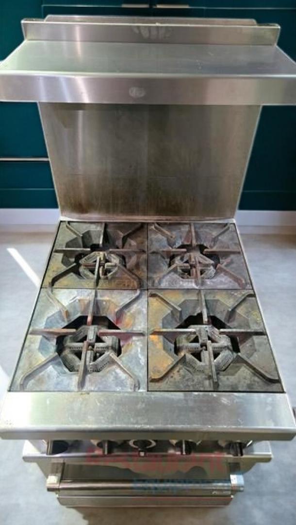 Commercial 4-burner gas range with oven, excellent condition, fully tested and operational, stainless steel finish.