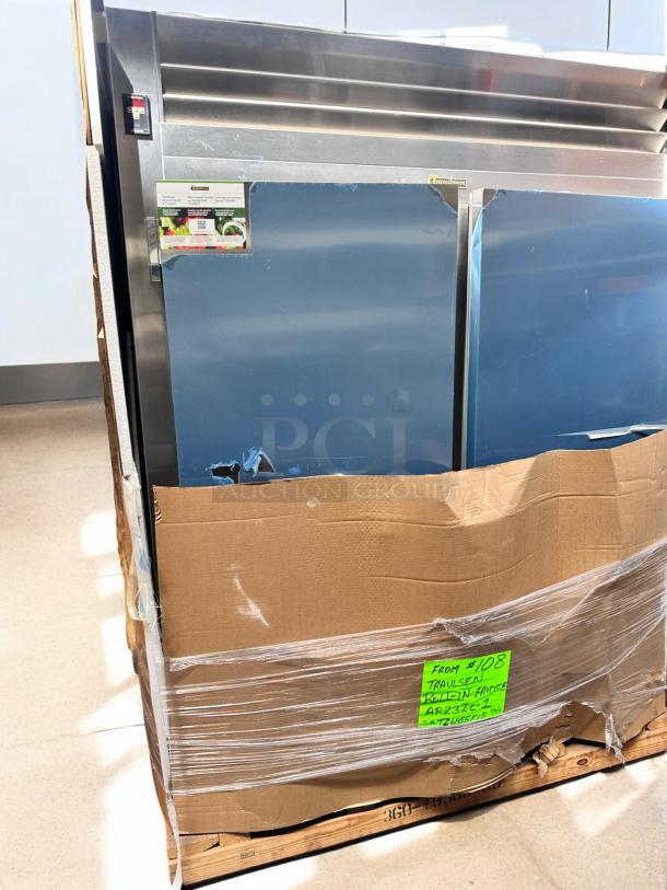 Brand new Traulsen AR23ZL-1 roll-in refrigerator, full-size single section, factory-sealed, visible labels indicating model and specifications.