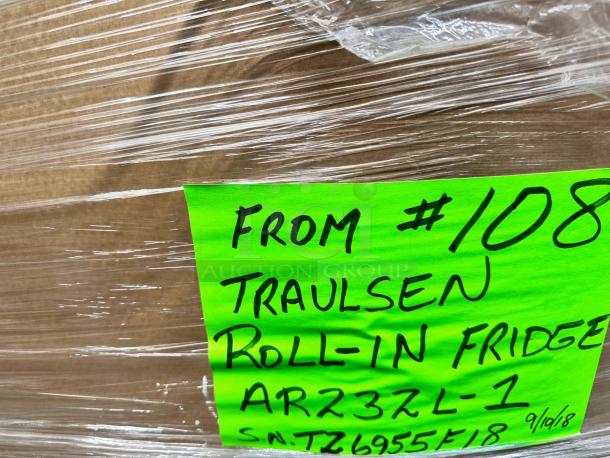 Brand new Traulsen AR23ZL-1 roll-in refrigerator with left hinge solid door. Factory sealed, model details visible on green label.