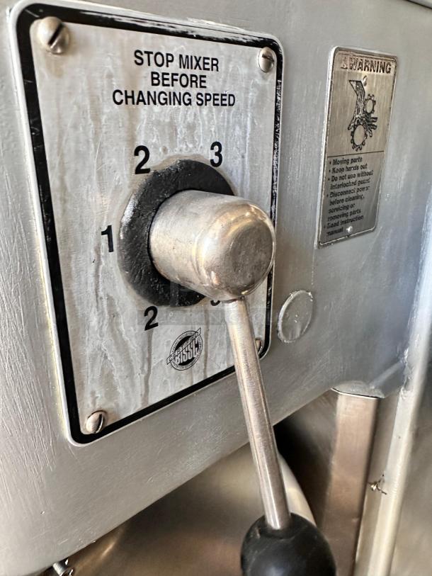 Hobart H800 mixer speed control lever, three-speed settings shown with safety warning label, stainless steel finish.