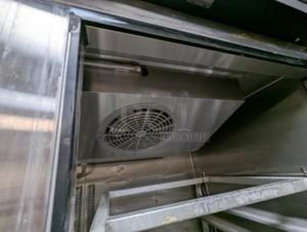 Turbo Air Double Door Refrigerator interior, featuring metal racks and digital temperature control, in outstanding condition.