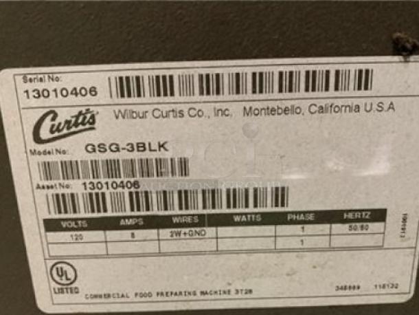 Label on Wilbur Curtis GSG-3BLK coffee grinder showing serial number 13010406, 120V, 8A. Made in USA.