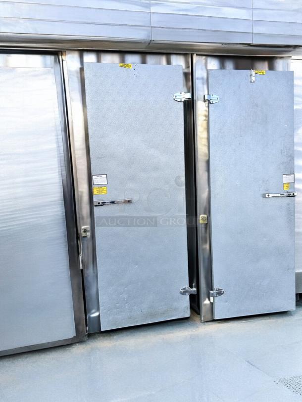 Set of 2 Norlake walk-in cooler/freezer doors, fully tested, great condition, stainless steel finish, visible safety labels.