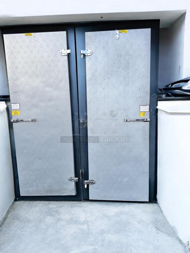 Norlake walk-in cooler/freezer doors, set of 2, great condition, tested and operational, metallic finish, visible safety labels.
