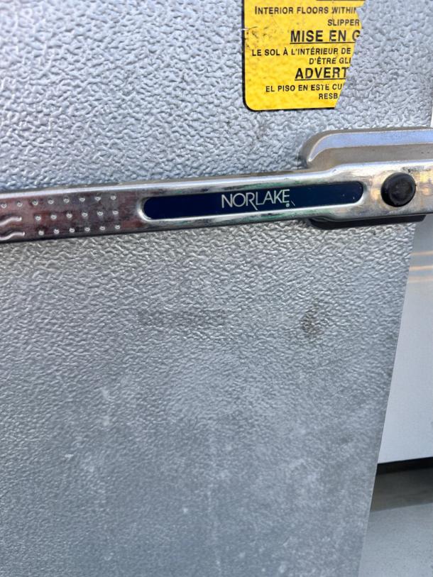 Norlake walk-in cooler/freezer doors in great condition with visible Norlake branding and safety warning label.