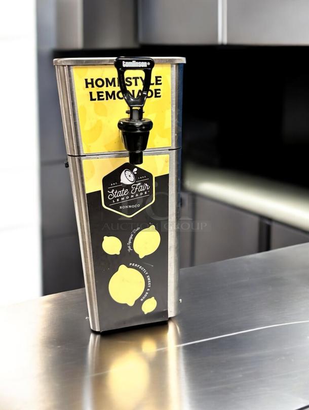 Newco FPM-1 Tomlinson beverage dispenser in superb condition, features a stainless steel build with lemonade branding.
