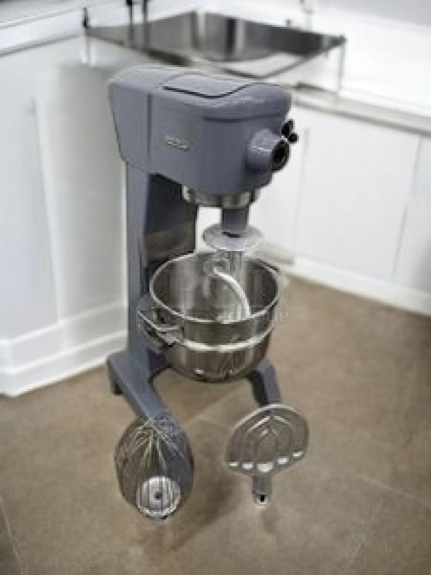 A large commercial planetary mixer by Hobart Corporation, featuring stainless steel bowl and attachments, in excellent condition.