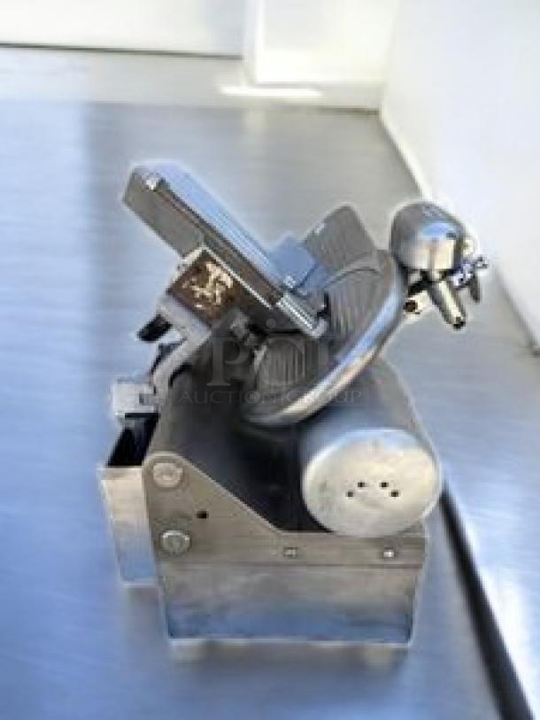 Globe Commercial Heavy-Duty Meat Slicer, model, in excellent condition, metal finish, automatic/manual, 115V, fully tested.