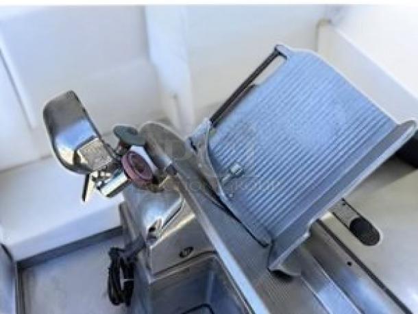 Globe heavy-duty meat slicer in excellent condition, model offers automatic/manual operation, tested and working, 115V.