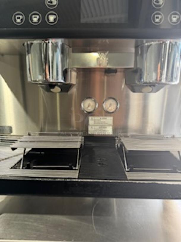 WMF Espresso Model 30.5500 machine with two grinders, hot water outlet, and steam wands. Features include heattable cup storage and a steam jet.