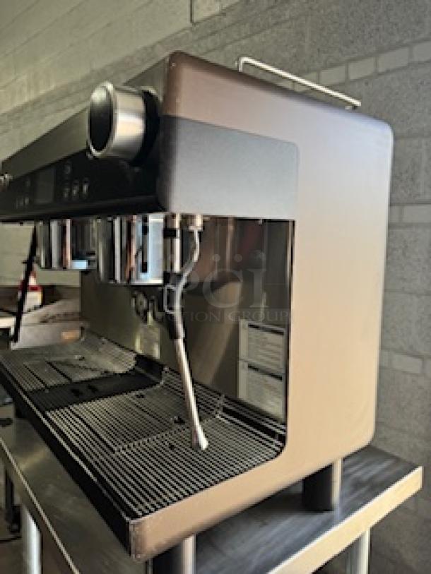 WMF Espresso Model 30.5500 coffee machine with dual grinders, hot water outlet, two steam wands, and heatable cup storage.