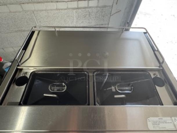 WMF Espresso Model 30.5500 with dual grinders, hot water outlet, steam wands, and heatable cup storage. Visible control panel.