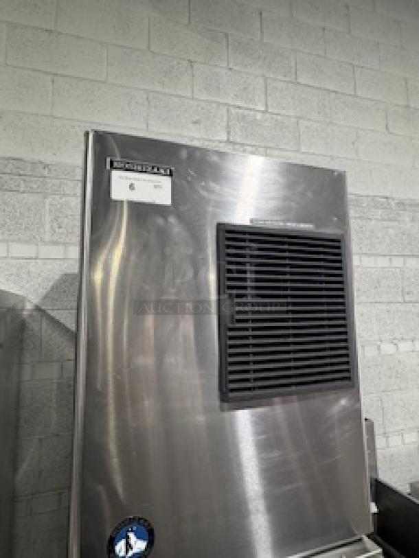 Hoshizaki KM-320MAH slim-line crescent cube ice machine with bin, 556 lb. capacity, air-cooled, 115v, stainless steel.