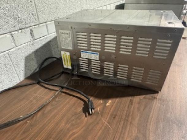 Meister Cook DMW-22-TDL heated cabinet, stainless steel, visible power cord, ventilation slots, control panel label.