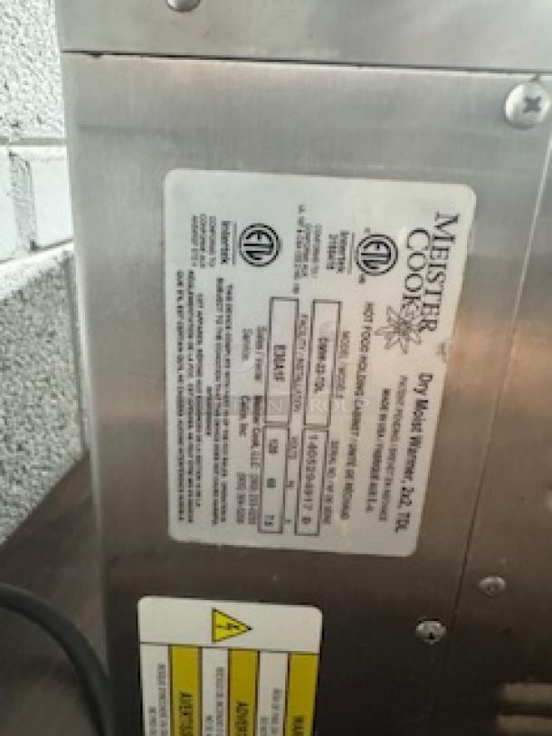 Meister Cook DMW-22-TDL food warmer, stainless steel, label showing model, specifications, and safety warnings.