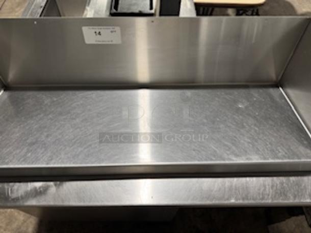 HEAVY DUTY 36" stainless steel wall shelf in excellent condition. Features durable construction with a smooth finish.