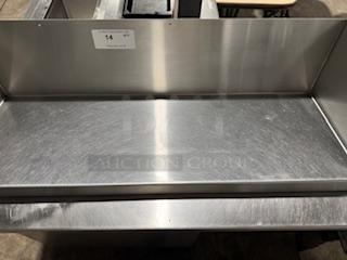HEAVY DUTY 36" stainless steel wall shelf in excellent condition. Features durable construction with a smooth finish.