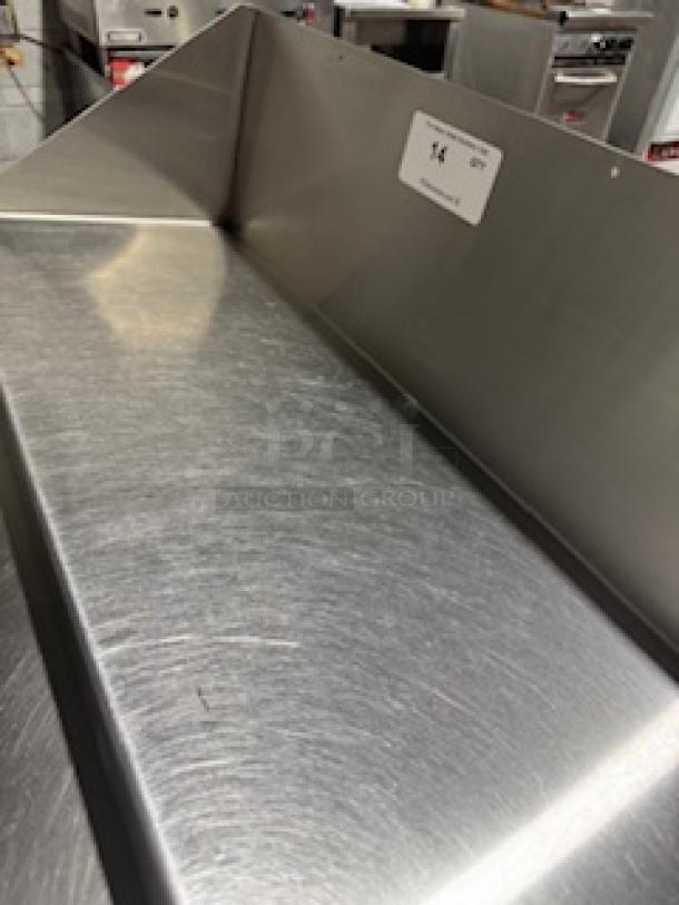 Stainless steel 36" heavy-duty wall shelf, in excellent condition, showing brushed finish surface with an ID tag labeled "14".