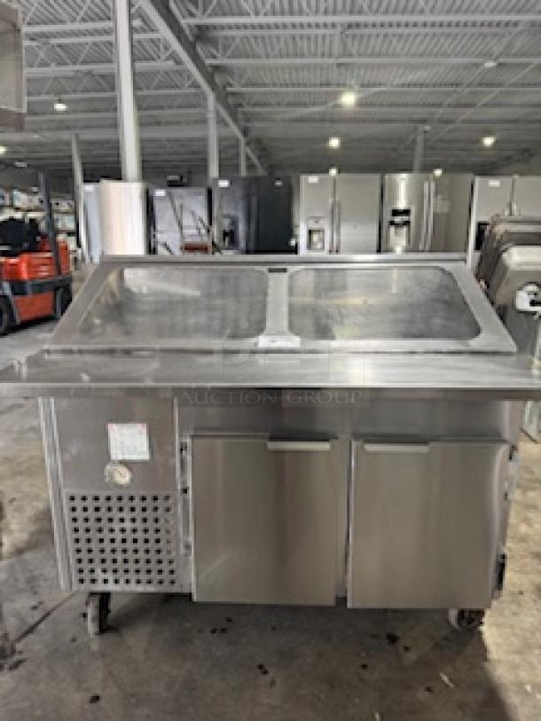 Refrigerated sandwich prep table with clear lid and dual stainless steel doors in good condition, ideal for commercial kitchens.