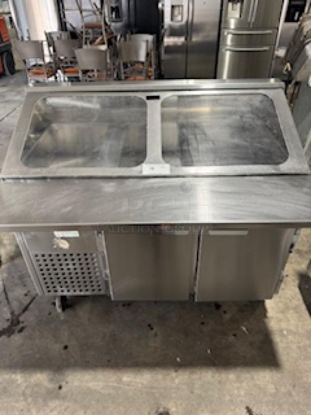 Refrigerated sandwich prep table with clear lid, stainless steel, dual-door storage, and visible control panel, in good condition.