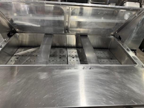 Refrigerated sandwich prep table with clear lid, stainless steel, multiple compartments, well-maintained condition.