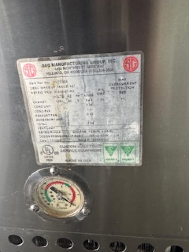 Refrigerated sandwich prep table with clear lid by S&G Manufacturing Group. Features a specification label and temperature gauge.