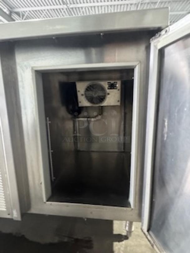 Three-compartment commercial sink with an integrated two-door cooler, stainless steel, ideal for restaurants and bars.