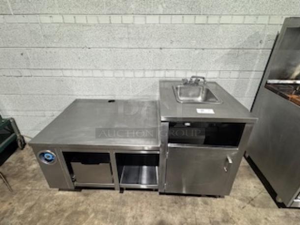Stainless steel table with single sink, features storage below, used condition, ideal for commercial kitchens.