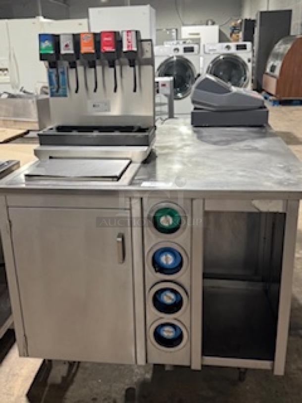 S&G MANUFACTURING BC7-1543 beverage dispenser station with four drink taps and cup holder in used condition.