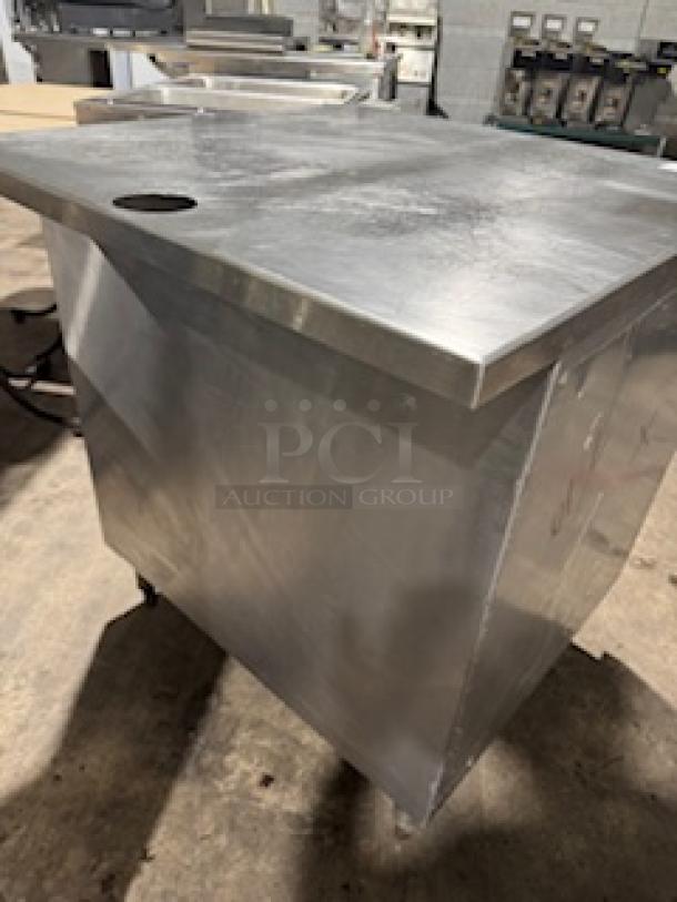 S&G Manufacturing stainless steel table, custom design, polished surface, durable construction, casters for mobility.