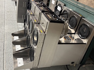 Multiple commercial coffee brewers lined up showing auction volume availability