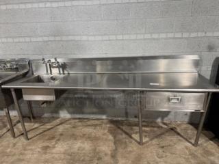 Heavy-duty Stainless Steel Prep Table with Integrated Single Bowl Sink and Right-Side Drainboard with Backsplash” Heavy-duty food-grade stainless steel (typically 304 or 430 grade) for corrosion resistance and easy cleaning. - Item #1210383