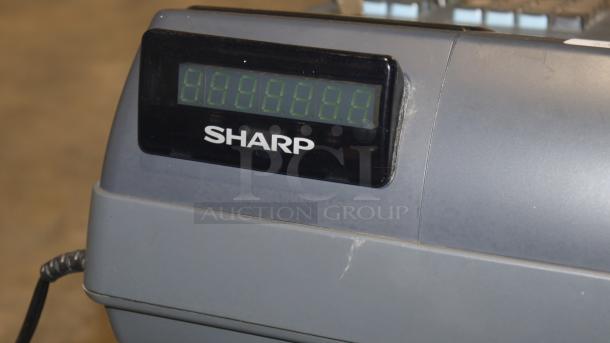 Sharp XE-A22S cash register, featuring a digital display, measures 14 x 14 x 12 inches. In good condition.