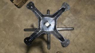 FLAT Tech KX22 22" x 22" self-stabilizing black table base, model CT2007, shown on a concrete floor, in good condition.